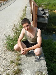 Small twink guy posing naked outdoors