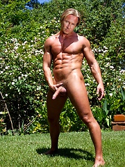 Handsome muscled man showing his strong naked body under sun