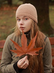 Baby-faced model in dainty lace lingerie and stockings.